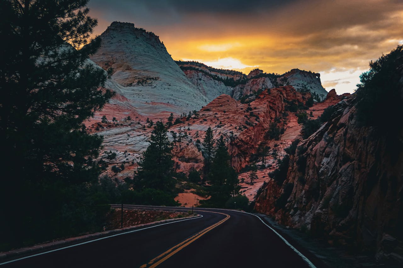Mastering the First Impression: Your intriguing post title goes here Scenic drive through Zion National Park at twilight with dramatic skies and majestic mountains.