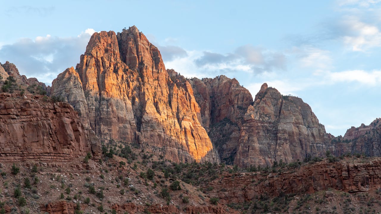 services-01 A breathtaking view of Zion National Park's towering cliffs during a vibrant sunset in Utah.