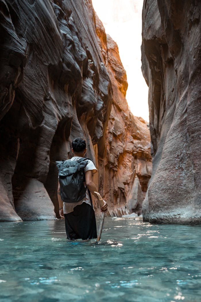 Crafting Captivating Headlines: Your awesome post title goes here Explore Zion's stunning Narrows with this adventurer wading through canyon waters.